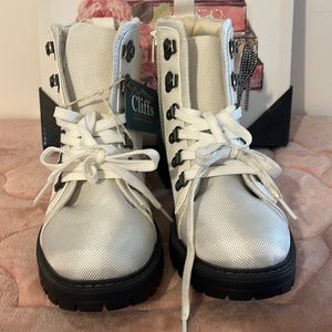 What leather and soft ankle boots with black trimming around the bottom